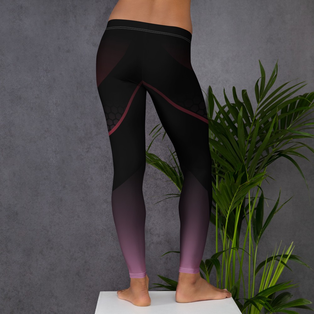 Person wearing black leggings with pink accents against a gray background