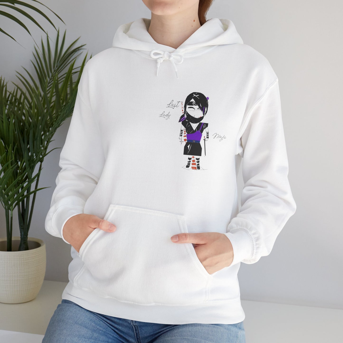 White hoodie with a lady ninja graphic design on a neutral background