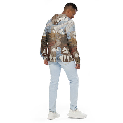 Person wearing a geometric patterned windbreaker and light blue jeans on a white background