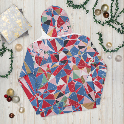 Colorful geometric-patterned jacket on a wooden surface with Christmas decorations.